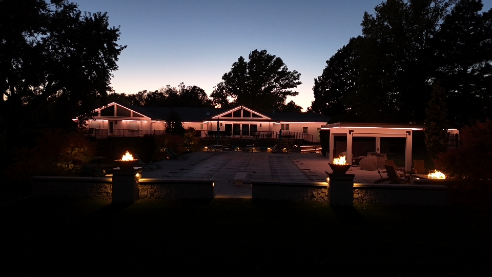 Home at night with warm roofline lighting on